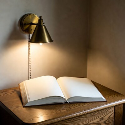 Open book under brass wall lamp