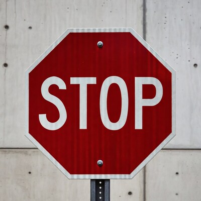 Red Stop Sign on Concrete Wall
