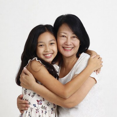 Asian mother hugging daughter