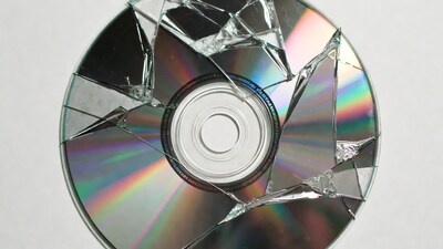 Broken CD on white background