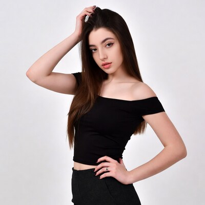 Young woman touching hair in black off-shoulder top