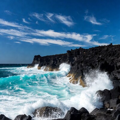 Waves crashing on black volcanic cliffs