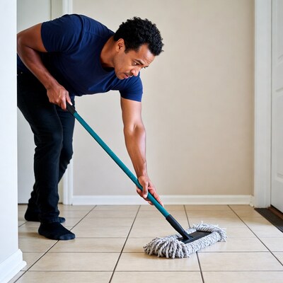 African-American man mopping floor