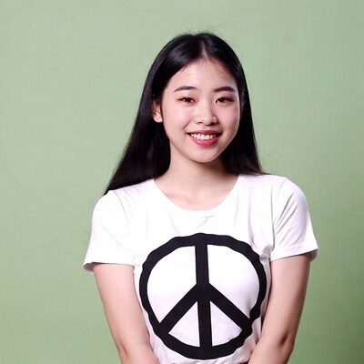 Asian woman in peace sign t-shirt