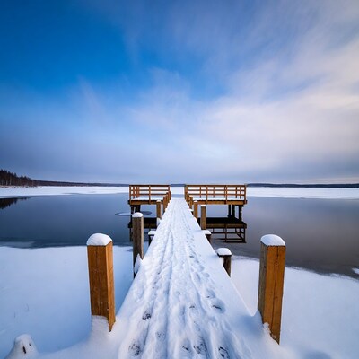 Snowy Wooden Pier on Frozen Lake