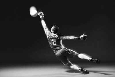 Soccer goalkeeper diving for ball