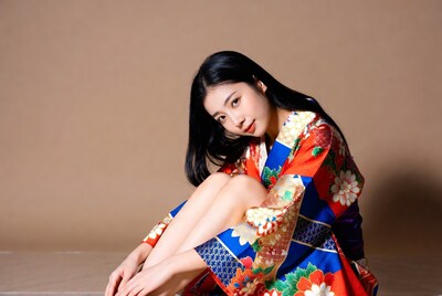 Asian woman in colorful kimono kneeling