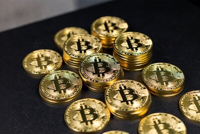 Golden Bitcoin Coins on Black Surface
