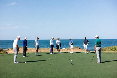 Group golfers on oceanfront putting green