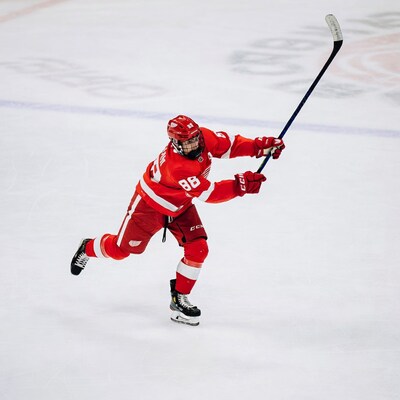 Red Wings Hockey Player Shooting Puck