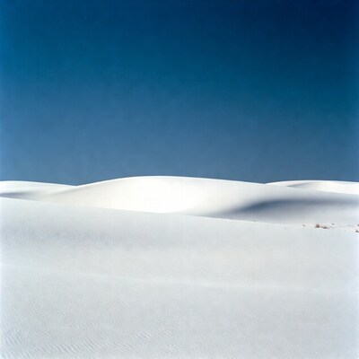 White sand dunes under blue sky