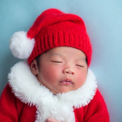 Newborn baby in Santa hat sleeping