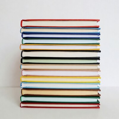 Stack of colorful books on white background
