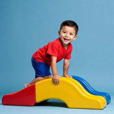 Asian boy climbing colorful playground bridge