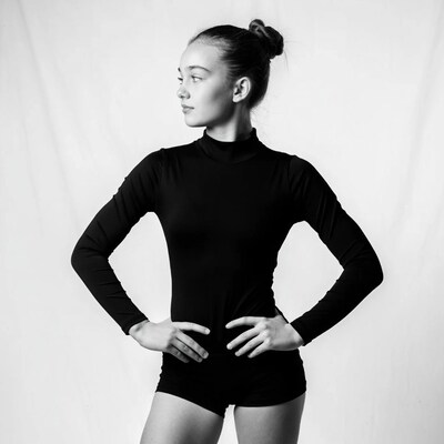 Girl in black leotard profile pose