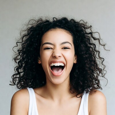 Mixed-race woman laughing with curly hair
