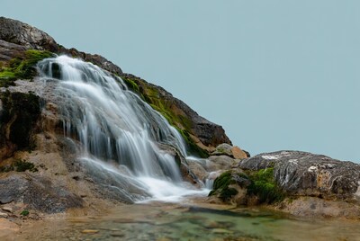 Waterfall cascading over mossy rocks