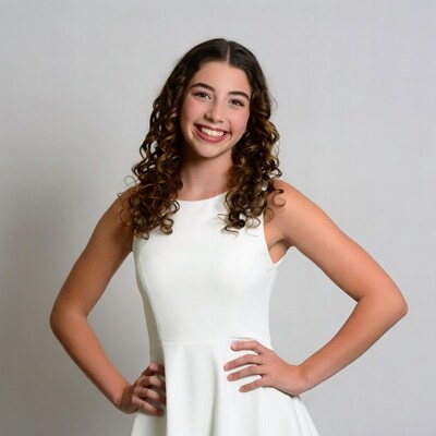 Teen girl smiling in white dress