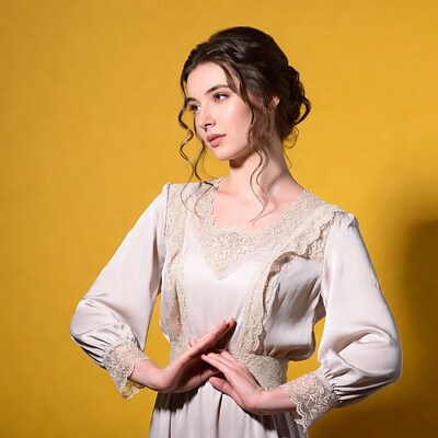 Woman in lace Victorian dress on yellow background