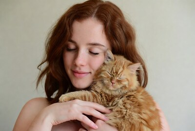 Woman holding ginger cat