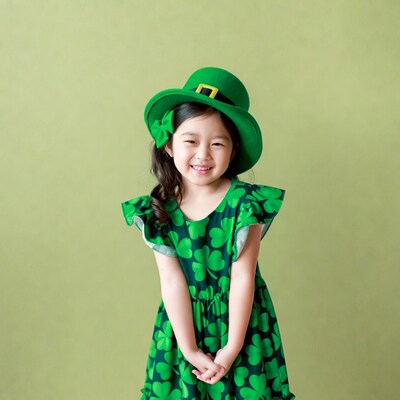 Asian girl in shamrock dress and leprechaun hat