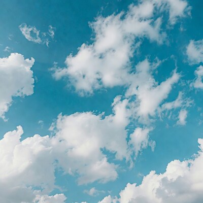 Fluffy white clouds in blue sky