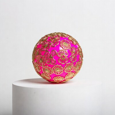 Pink gold flower ornament on white pedestal