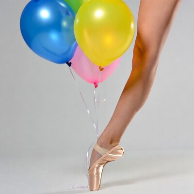 Woman's leg in pointe shoes with balloons