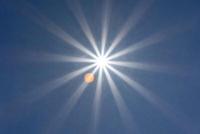 Bright sun rays in blue sky