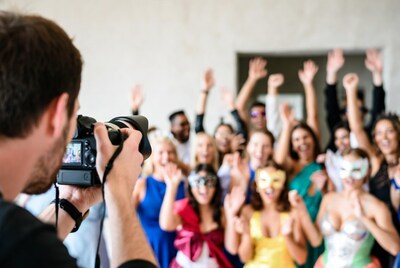 Photographer capturing costumed party crowd