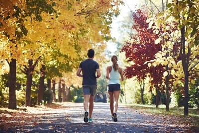 Couple jogging fall forest path
