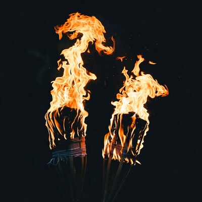 Two Burning Torches on Black Background