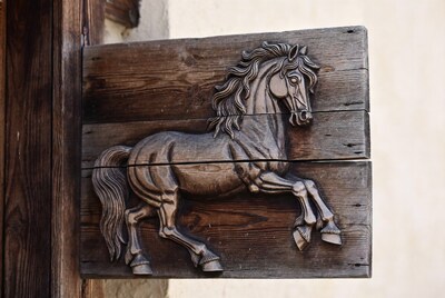 Carved wooden horse relief