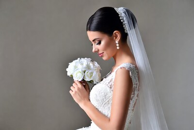 Bride holding white rose bouquet