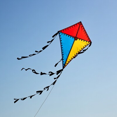 Colorful kite flying in blue sky