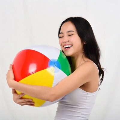 Asian woman hugging beach ball