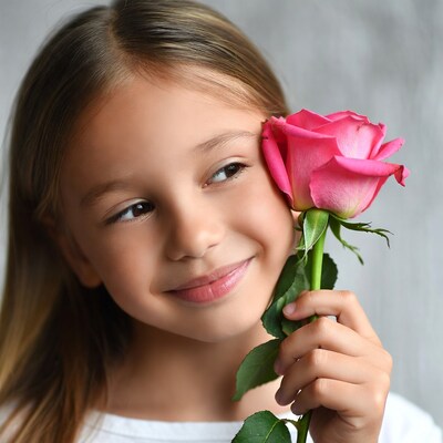 Girl holding pink rose