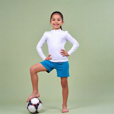 Girl balancing soccer ball on foot