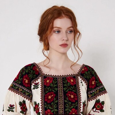 Redhead woman in embroidered blouse