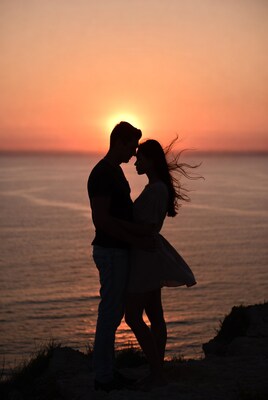 Silhouette couple embracing at sunset