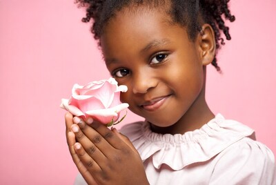 Black girl holding pink rose