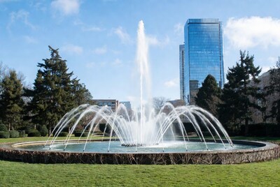 Fountain spraying water with skyscraper