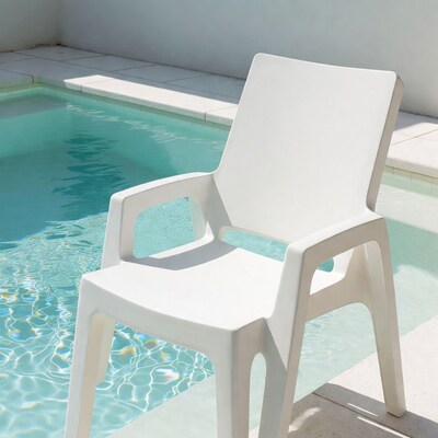 White plastic chair by pool