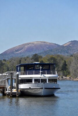 Yacht docked at dock with Stone Mountain