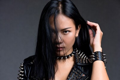 Asian woman in spiked leather jacket