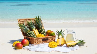 Pineapples and Mangoes in Wicker Basket on Beach