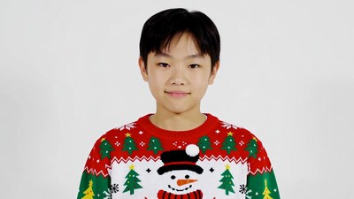 Asian boy in Christmas ugly sweater