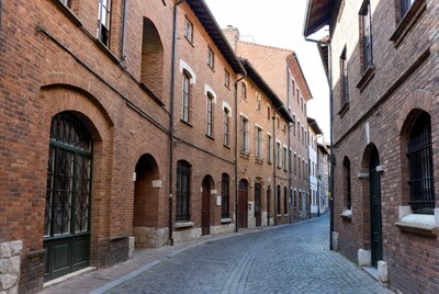 Narrow Cobblestone Street with Brick Buildings