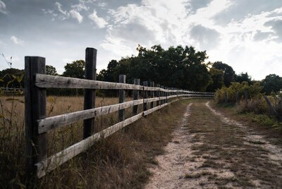 Wooden fence along dirt path