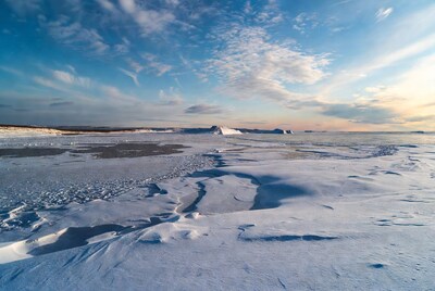 Icebergs in Snowy Arctic Landscape